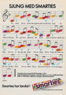 Reklam för Smarties där de små godisbitarna är noter på ett notblad med instruktioner om att sjunga sången